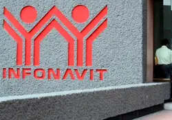 Letras y logo del Infonavit en color rojo sobre pared gris 