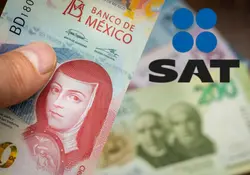 Mano sostiene billete de 100 pesos y logo del SAT 