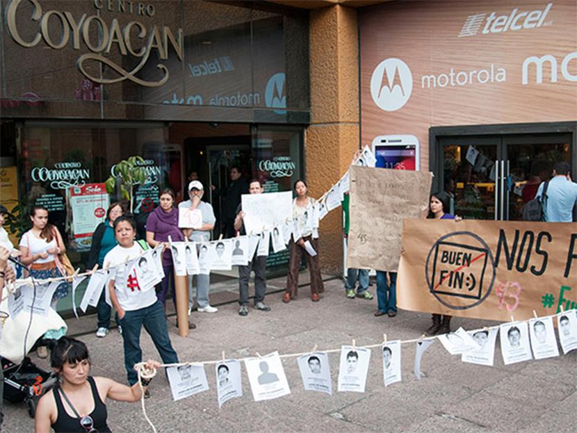Un grupo de personas se manifestaron en el centro comercial Coyoacán para exigir la aparición de los 43 normalistas de Ayotzinapa, en el marco del Buen Fin. Foto Cuartoscuro