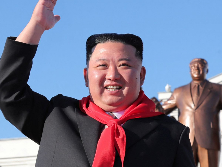 Kim Jong Un vestido de saco negro y pañuelo rojo en el cuello