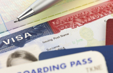 Vista de una visa americana con un boleto de avión.